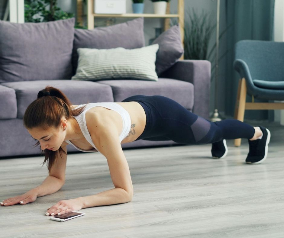Woman holding a strong plank position to build core stability for improved scuba buoyancy control.