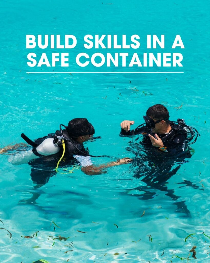 Two scuba divers practicing skills together in a pool to build confidence and reduce dive anxiety