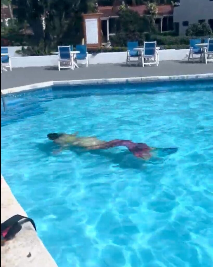 Woman practicing mermaid swimming with a monofin, emphasizing breath control and body awareness