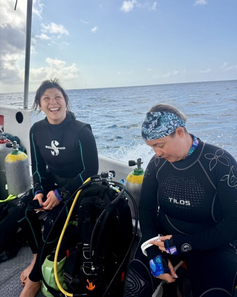Small group of beginner scuba divers preparing gear on a boat in the Philippines