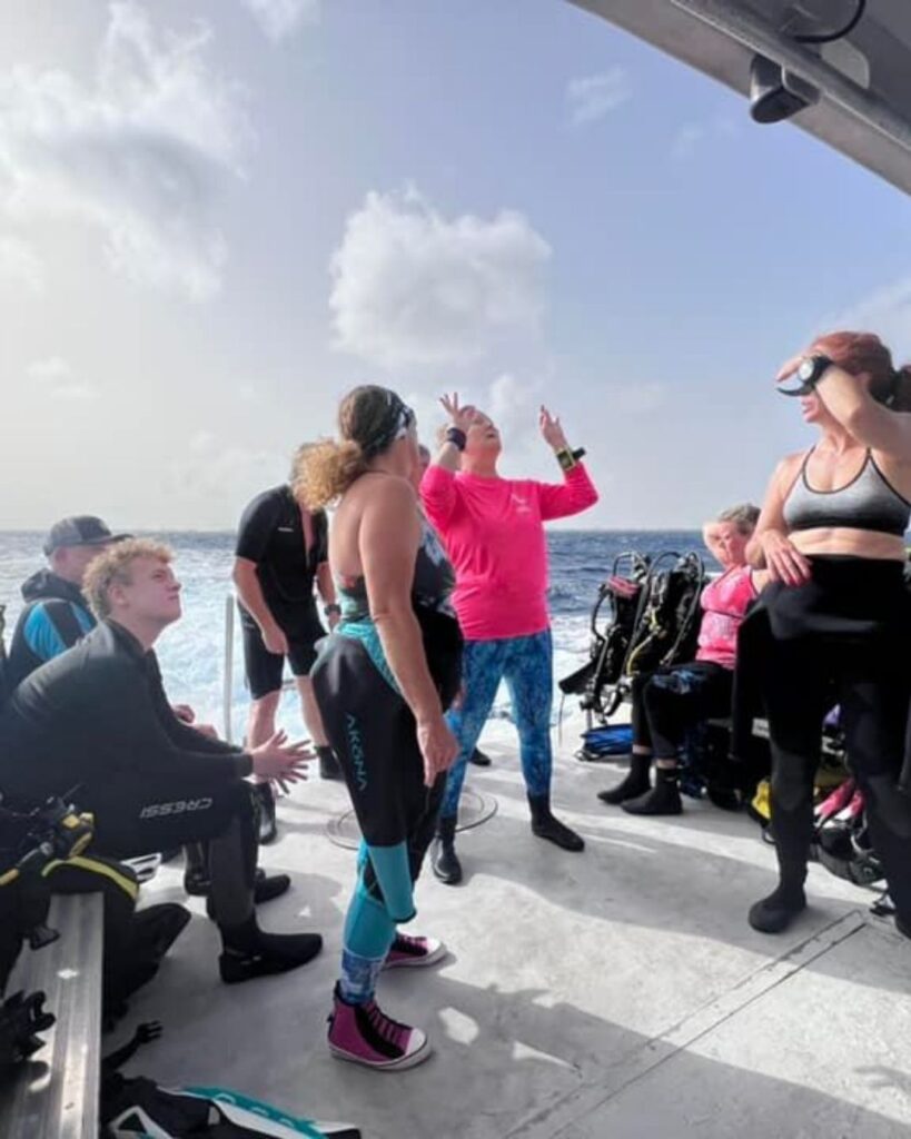 Divers preparing to enter clear water from a boat at Klein Bonaire reef