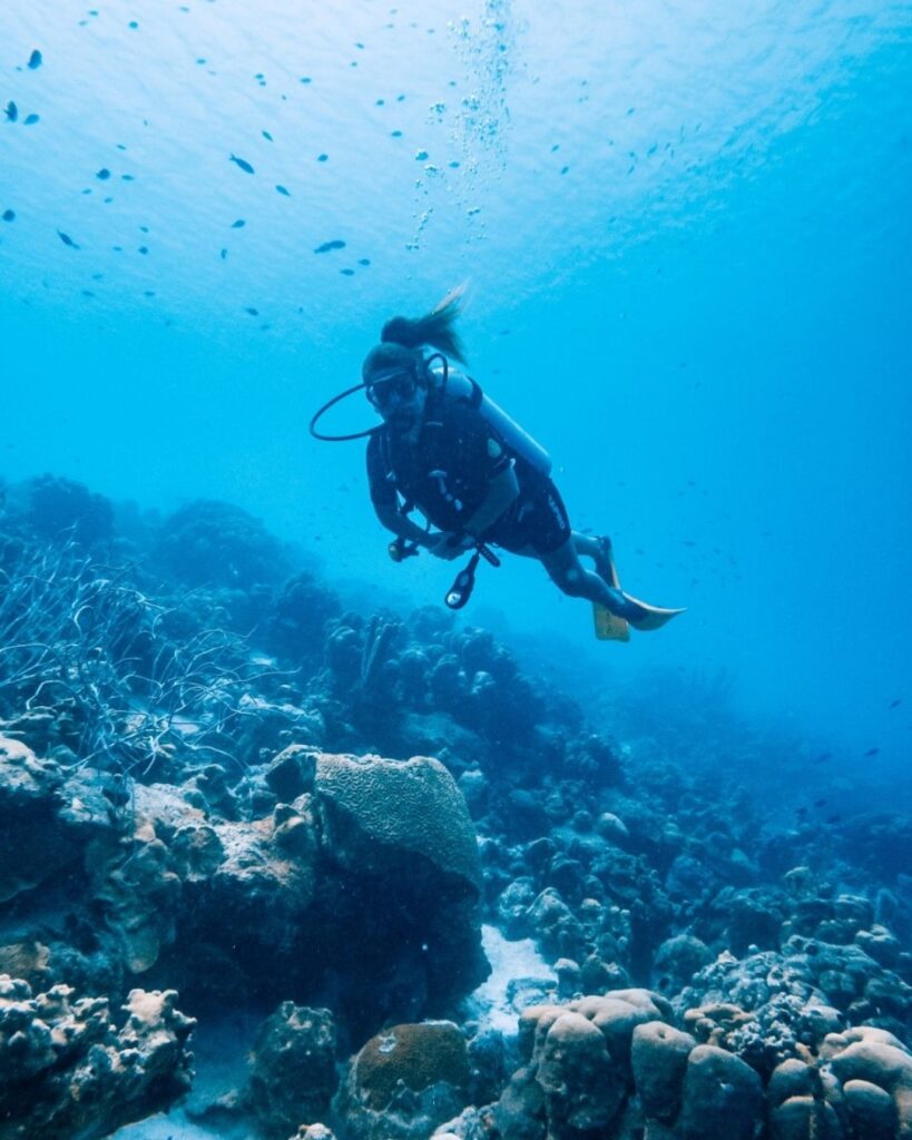 Scuba diver underwater in Bonaire with clear visibility and visible reef