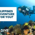 Female scuba diver hovering above a coral reef in the Coral Triangle during a Philippines dive adventure