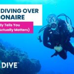 Women over 50 scuba diving calmly in clear water in Bonaire