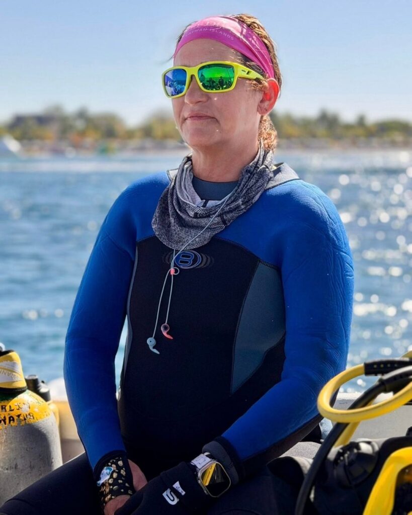 Woman just surfaced from scuba diving, showing a calm regulated nervous system state after somatic diving practice